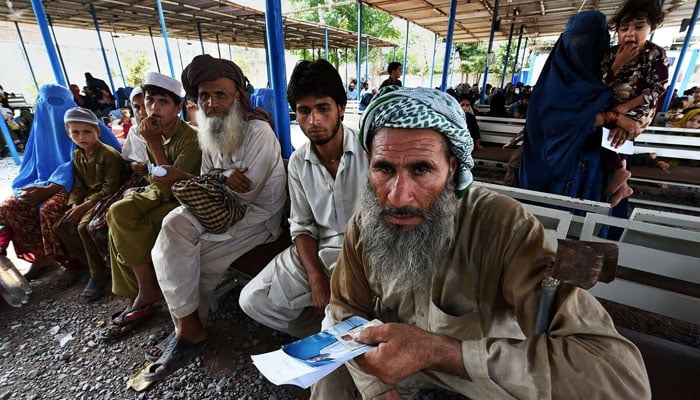 Afghan refugees seen waiting. — AFP/File