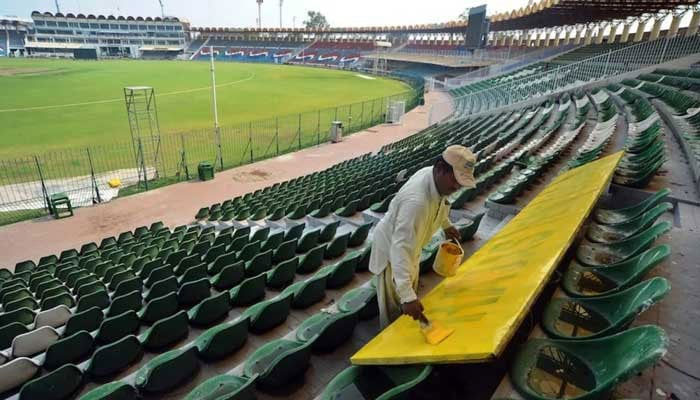 A man seen painting chairs at Gaddafi Stadium in Lahore in this undated image. — AFP/File