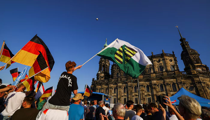 People wave flags on the day of the campaign of Alternative for Germany (AfD) party co-leaders Alice Weidel and Tino Chrupalla for the Saxony state elections in Dresden, Germany on August 29, 2024. — Reuters