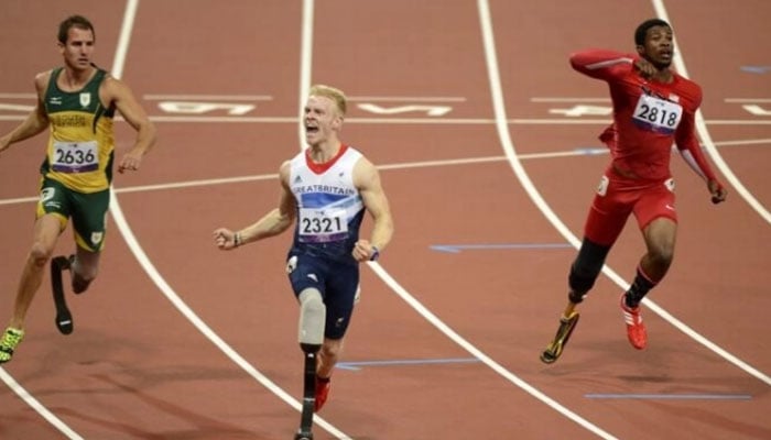 Britain’s Jonnie Peacock (centre) reacts during Paralympic 100 metres race. — AFP/File