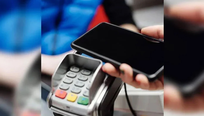 A representational image of a person using his cellphone for a digital transaction. — Pexels/File