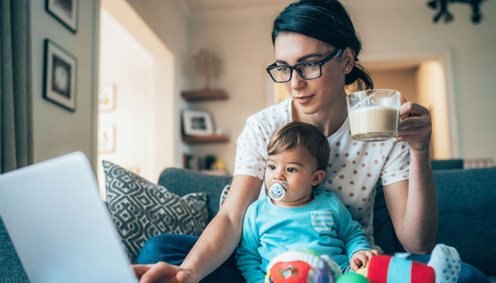 A representattional image of  working mother from home with her toddler sitting on her laptop. — X@filadendron/file