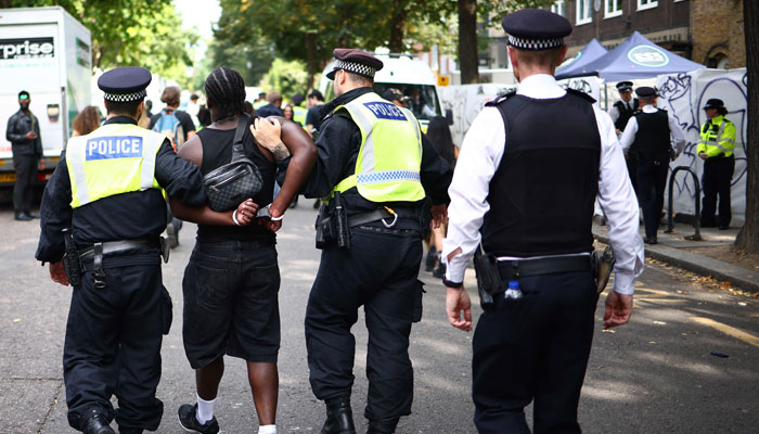 Police officers make an arrest at the Notting Hill Carnival in west London on August 26, 2024. — AFP