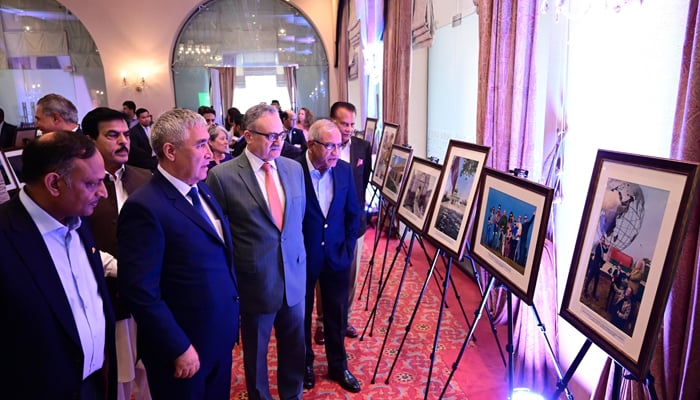 Foreign Secretary Muhammad Syrus Sajjad Qazi, CEO of Serena Hotels Aziz Boolani and ambassador of Turkmenistan Atadjan Movlamov and others watching photo exhibition at Serena Hotel Islamabad image released on August 26 2024. — Facebook/@SerenaHotelsOfficial