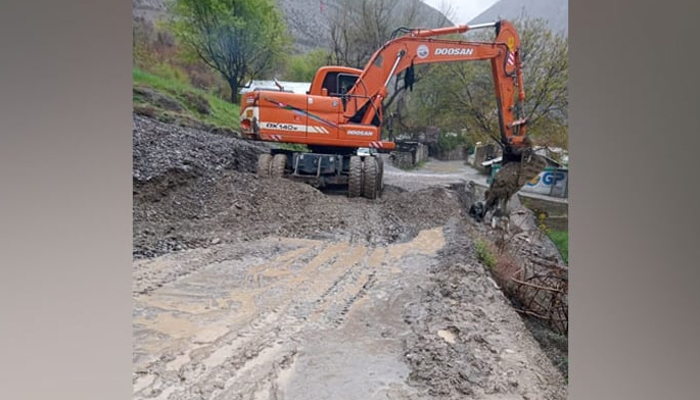 In this image district administrations machinery clearing roads blocked by the landslides and sludge left by the floods on April 14, 2024. — Facebook/@DCLowerChitral