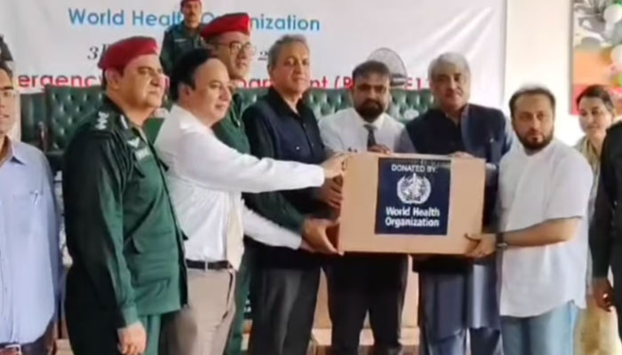 (From right) Punjab Health Ministers Khawaja Imran Nazir  and Khawaja Salman Rafique distribute Tyvek suits among the rescuers at the Command and Control Centre, Rescue 1122, Shama office as special guests on September 3, 2024. — Screengrab via Facebook/Khawaja Salman Rafique