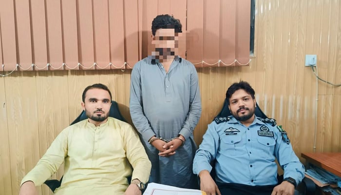 Two Federal Investigation Agency (FIA) officials are seen in this picture with a fake ASI of the FIA arrested (centre) September 4, 2024. — Facebook/@FIAAgencyOfficial