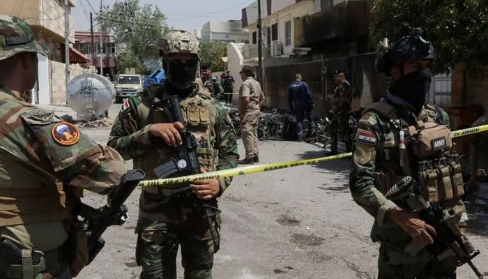 Members of Iraqi security forces stand near the debris of an armed drone shot down by Iraqs air defences in Kirkuk, Iraq on August 29, 2024. — Reuters