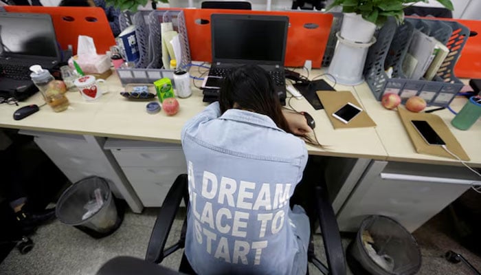 This representational image shows an employee taking a nap in her seat after lunch on April 21, 2016. — Reuters