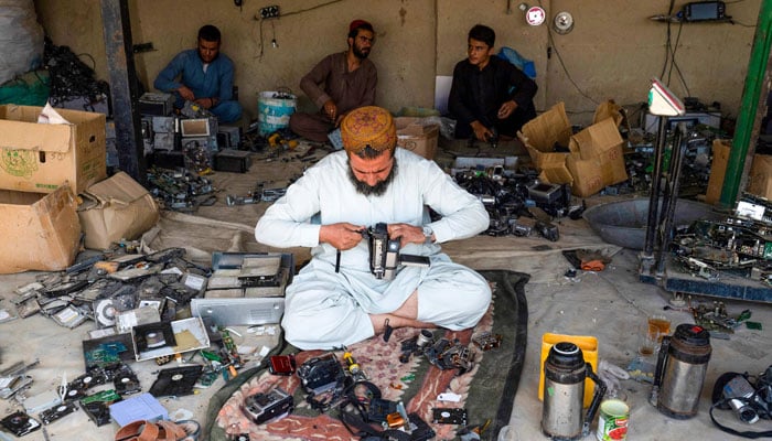 In this photo taken on August 25, 2024, Afghan smelter Sayed Wali Agha extracts gold from cameras and car navigation screen devices at a workshop near the Afghanistan-Pakistan border in Spin Boldak district, Kandahar province. — AFP