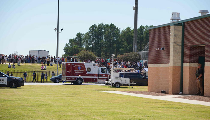 Students wait to be picked up by their parents after a shooting at Apalachee High School in Winder, Georgia on September 4, 2024. — AFP