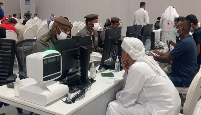 UAE officials attend to people at seeking various visa-related facilities in this undated image. — Supplied