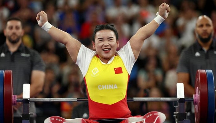 Guo Lingling celebrates after winning gold in the womens up to 45 kg powerlifting class at Paris 2024. —AFP