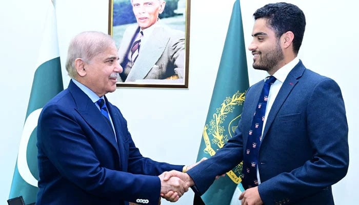 Prime Minister Shehbaz Sharif shakes hands with Pakistans newly-appointed Ambassador-at-Large for Youth Empowerment Israr Khan Kakar. — Photo by author