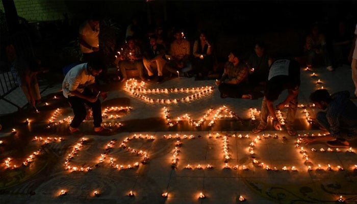 Health professionals light up earthen lamps in Kolkata calling for justice after the rape and murder of a doctor at a state-run hospital. — AFP/file