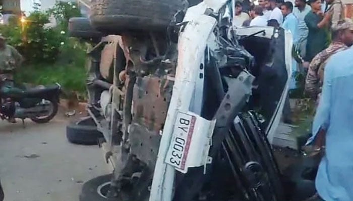 A damaged vehicle is lying upside down due to an accident on Karsaz Road in Karachi on August 19, 2024. — The News