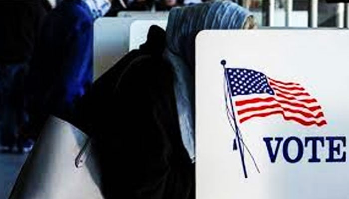 This undated picture shows a woman is casting her vote during the US elections. — Reuters