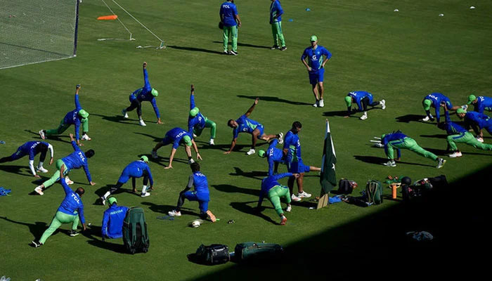 Pakistans cricketers warm up before the team practice session at the National Stadium in Karachi on December 15, 2022, ahead of the third cricket Test match between Pakistan and England. — AFP