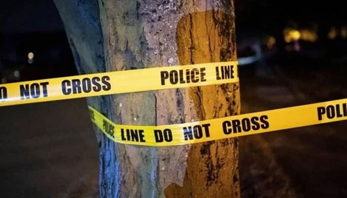 A representational image of a police tape wrapped on a tree at a crime scene. — AFP/File