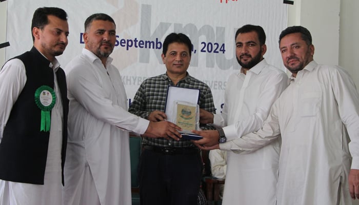 Shaheed Benazir Bhutto University (SBBU) Director Finance Sahibzada Murad Hussain (1st from right) and others presenting shield and certificates to Chairman of the Department of Pharmacy Dr Shujaat Ahmed at the end of a five-day training workshop on Nutrition in Emergencies at Sheringal dir seen in this image released on September 6, 2024. — Facebook/@fb.sbbu.edu.pk