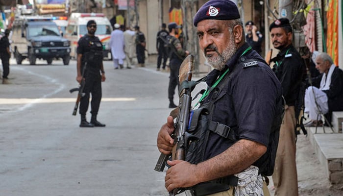 This image shows a police personnel standing guard in Peshawar. — AFP/File