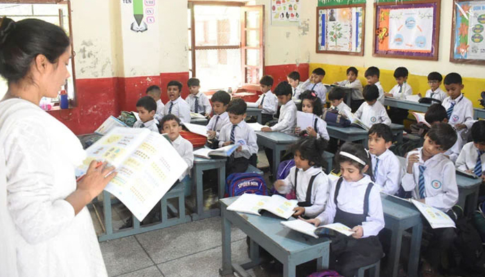 A representational image of teacher is reading a lesson to students in her class seen in this image. — Online/File