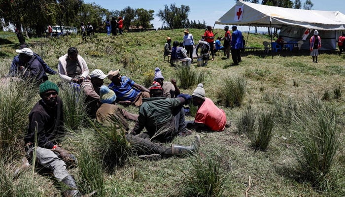 Grieving relatives of Hillside Endarasha Academy fire tragedy,wait to receive counselling at an emergency care and counselling centre set up by Kenya Redcross members outside the school in Endarasha, Nyeri county on September 7, 2024. — AFP