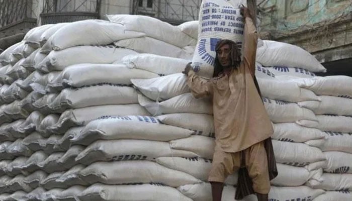 A labourer carries a sack of sugar. — AFP/File