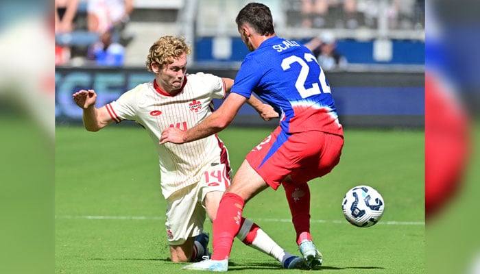 Canadas forward Jacob Shaffelburg (L) kicks the ball away from United States defender Joe Scally during the first half of an international friendly football match between USA and Canada at Children´s Mercy Park in Kansas City, Kansas, on September 7, 2024. — AFP