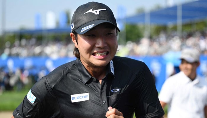 Kensei Hirata of Japan celebrates his victory at the end of the 40th Shinhan Donghae Open golf tournament at Club72 Country Club in Incheon on September 8, 2024. — AFP