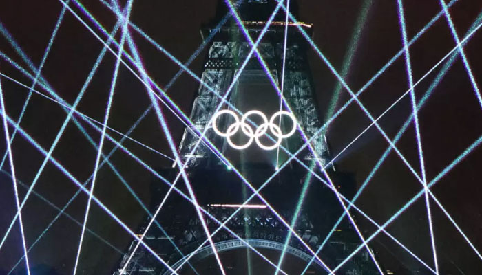 A spectacular laser show at the Eiffel Tower during the Olympic opening ceremony. — AFP/File