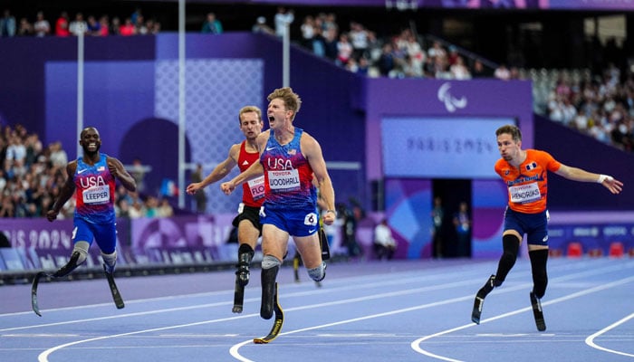 US Hunter Woodhall celebrates after winning the gold medal during the Mens 400m T62 final event at the Paris 2024 Paralympic Games in Saint-Denis, outside Paris on September 6, 2024. — AFP