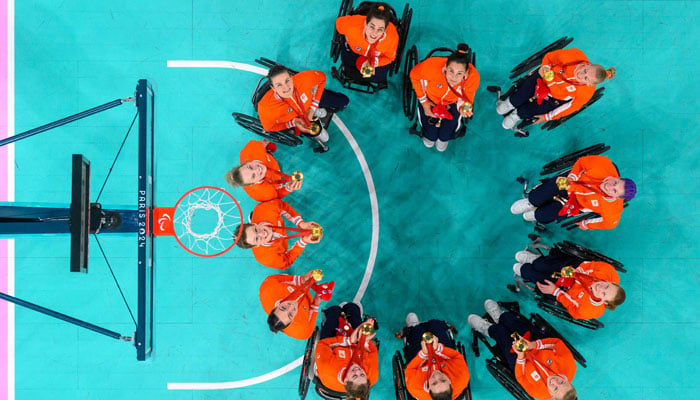 An overview shows the Netherlandss national team posing with their gold medals after winning against the USA team in the womens wheelchair basketball final #48 during the Paris 2024 Paralympic Games in Paris on September 8, 2024. — AFP