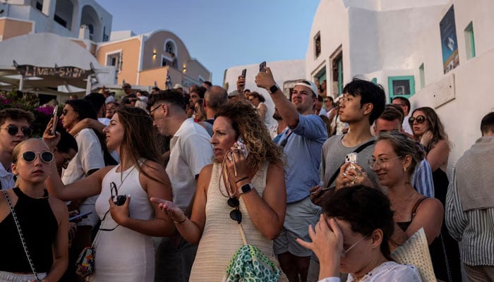 Tourists view Santorini’s famed sunset, on Santorini, Greece, July 25, 2024. — Reuters