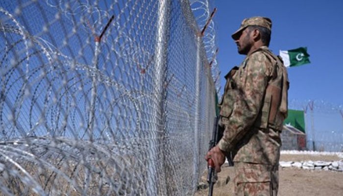 A Pakistan Army soldier stands guard at the border fence with Afghanistan in South Waziristan. — AFP/File