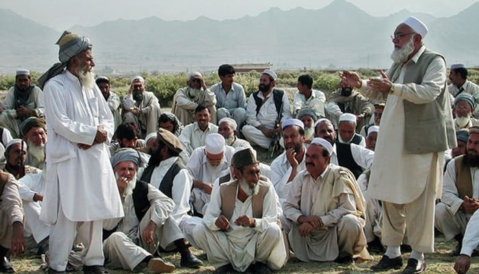 A representational image shows members of a Jirga sitting while an elder speaks. — AFP/File