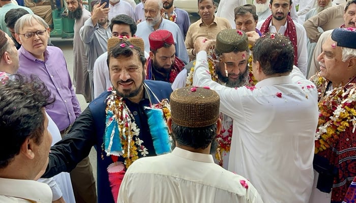 The panel contesting election in KP Sarhad Chamber of Commerce and Industry is garlanding the members of with urban flowers and others are seen in this image released on September 9, 2024. — Facebook/@Haji Ghulam Ali Former Governor of Khyber Pakhtunkhwa