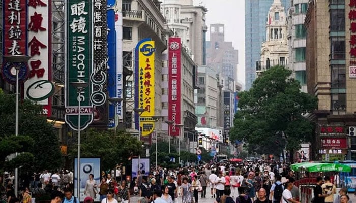 A representational image showing people walking at a market in China. — Reuters/File