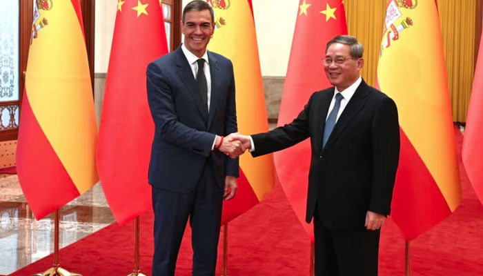 In this handout photograph taken by the Spanish Prime Ministers office La Moncloa on Sep 9, 2024, Spains Prime Minister Pedro Sanchez shakes hand with Chinas Premier Li Qiang during his visit in Beijing. — AFP