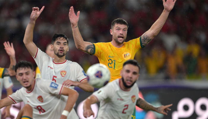 Australias Cameron Burgess challenges Indonesias Sandy Walsh (centre L) and Calvin Verdonk during the 0-0 draw in Jakarta.— AFP/file