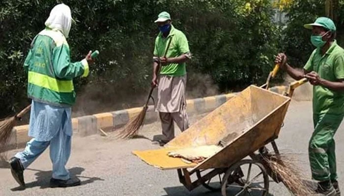 This representational image shows local government workers cleaning the road. — APP/File