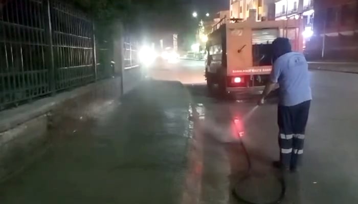 The anti-smog grand cleaning operation is ensuring the elimination of dust by washing the streets of the city late at night September 11, 2024. — Screengrab/Facebook/@www.rwmc.org.pk