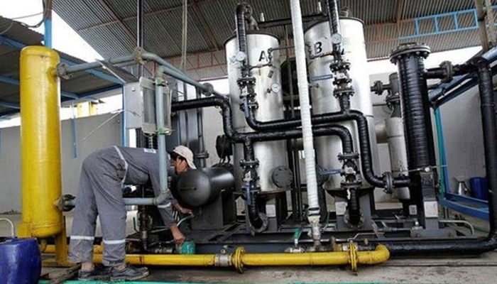 A worker drains water from a gas filter at the Egas processing plant on March 10, 2017. — Reuters