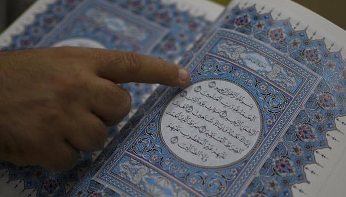 A representational image showing a person reading the Holy Quran. — AFP/File