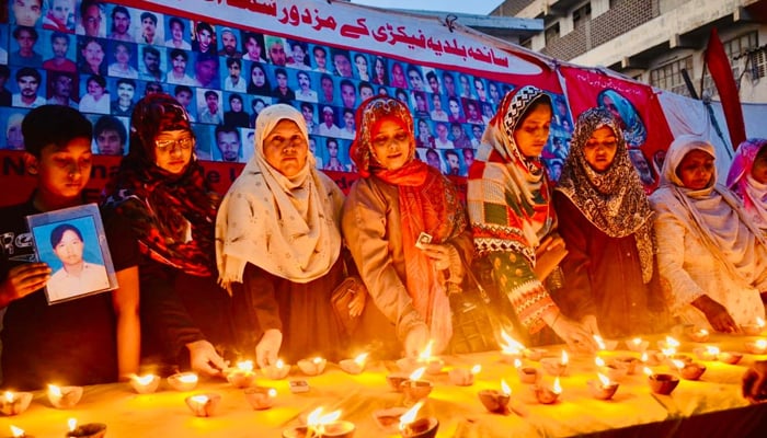 On the occasion of the 12th anniversary of the martyrs of the Baldia factory tragedy, their families are lighting lamps in memory of their loved ones September 11, 2024. — Reporter