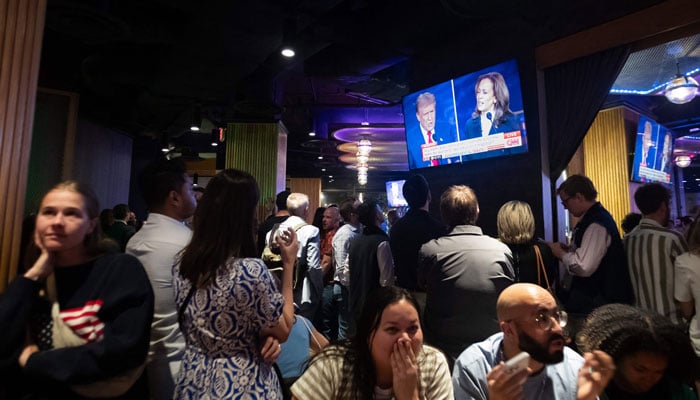 People attend a watch party for the US Presidential debate between Vice President and Democratic presidential candidate Kamala Harris and former US President and Republican presidential candidate Donald Trump at The Admiral in Washington, DC, on September 10, 2024. — AFP