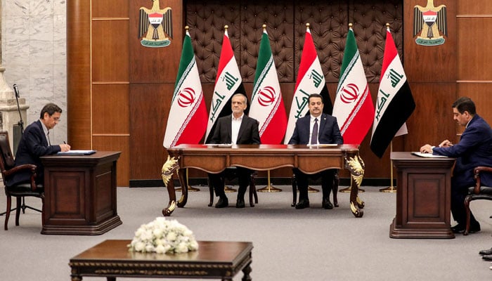 Iraqs Prime Minister Mohammed Shia al-Sudani (C-R) and Irans President Masoud Pezeshkian (C-L) attend a ceremony signing memoranda of understanding between Iraq and Iran at the government palace in Baghdad on September 11, 2024. — AFP