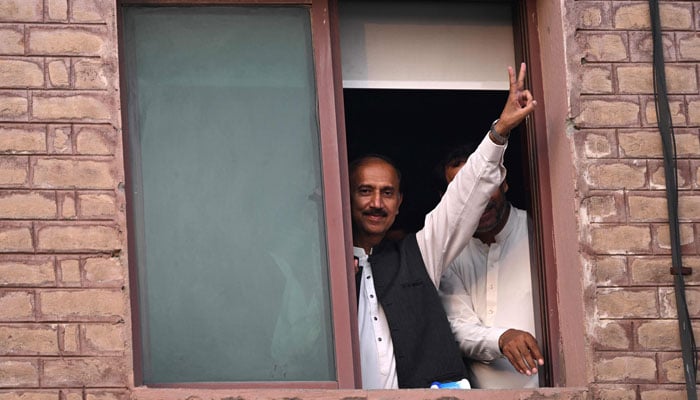 Pakistan Tehreek-e-Insaf (PTI) party leader and senior lawyer Muhammad Shoaib Shaheen, shows a victory sign as he and other MPs appear before an anti-terrorism court in Islamabad on September 10, 2024. — AFP