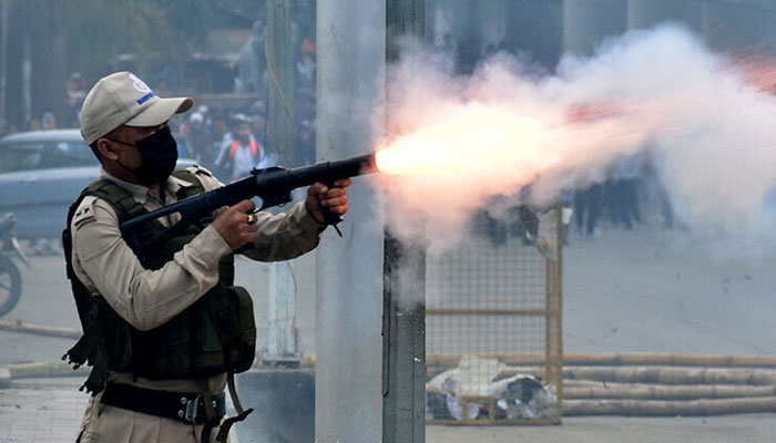 A police officer fires a tear smoke shell to disperse demonstrators during a protest march by the students demanding an end to the latest spurt of ethnic violence, in Imphal, Manipur, India, September 10. — Reuters