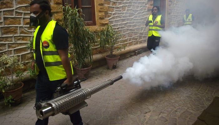 A worker fumigates a streets as a preventive measure against diseases-carrying mosquitoes during the monsoon season seen in this image on September 25, 2022. — AFP